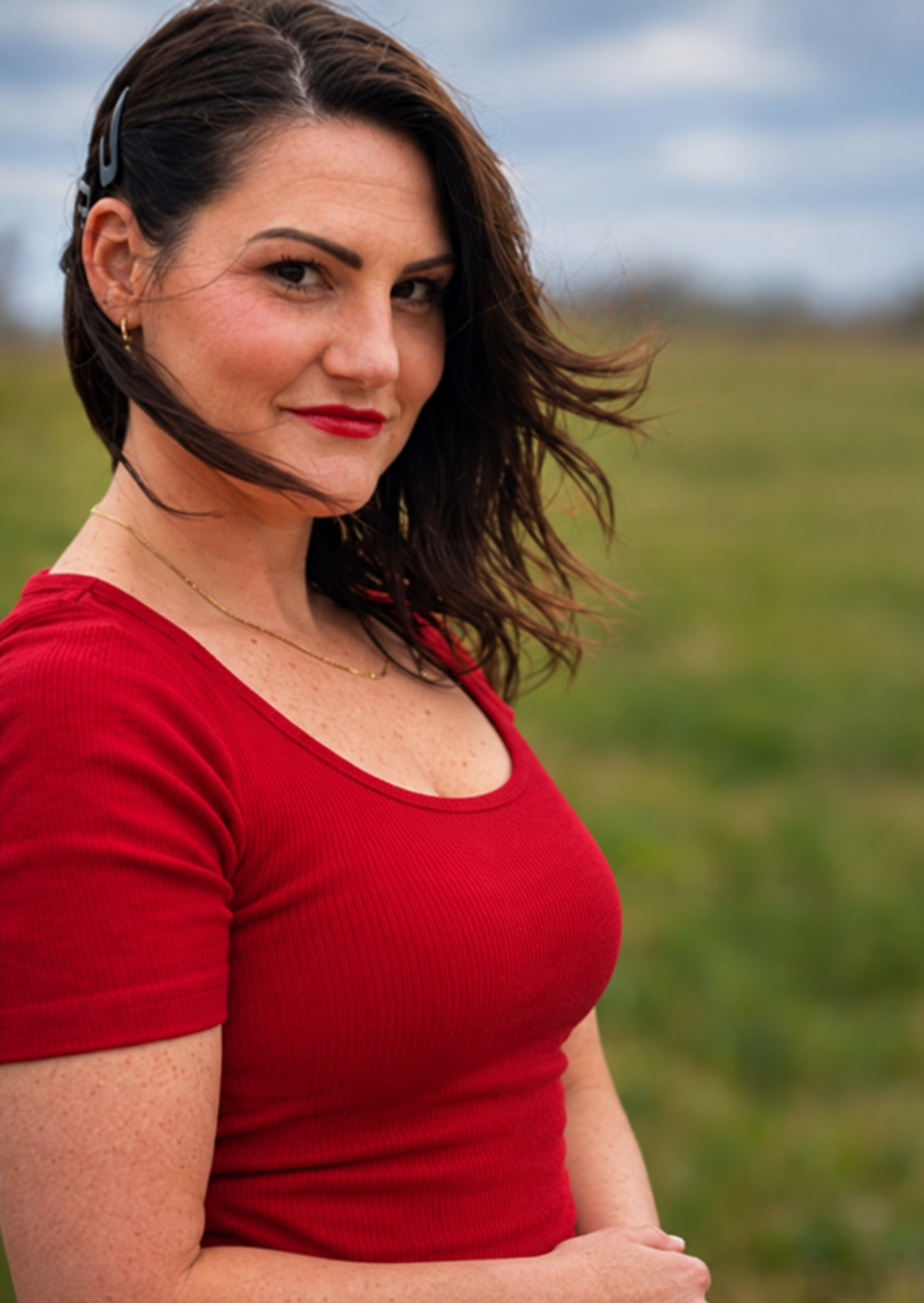 Kara Pederson, therapist and author, outdoors in a red shirt